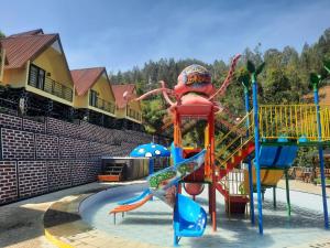 a water park with a playground with a slide at Hotel Nature Bromo and Resort in Pasuruan