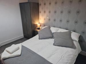 a bedroom with a white bed with two pillows at Fantastic 4 Bed for Contractors and Families in Old Walker