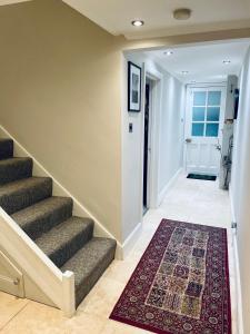 un pasillo con escaleras y una alfombra en el suelo en Grade II boho home in the heart of Oxford St. en Southampton