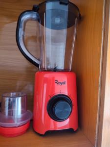 a red blender sitting on top of a table at Kemzie's Apartments in Port Harcourt