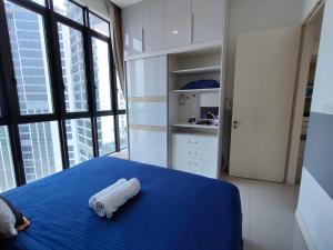 een slaapkamer met een blauw bed en een groot raam bij Zuncy T23 Legoland Puteri Harbour Sunway Iskandar Nusajaya JB Johor in Nusajaya