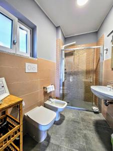 a bathroom with a toilet and a sink at A Casa di Alessandra - Rooms in Castellabate