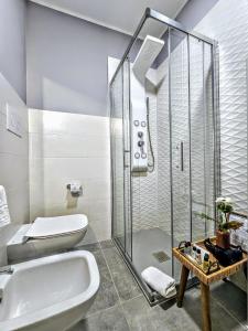 a bathroom with a shower and a toilet and a sink at A Casa di Alessandra - Rooms in Castellabate