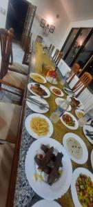 a long table with plates of food on it at New venecia resort in Ain Sokhna