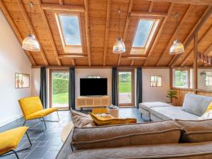 a living room with a couch and a tv at Holiday Home in Reest Valley near Forest & Pond in IJhorst