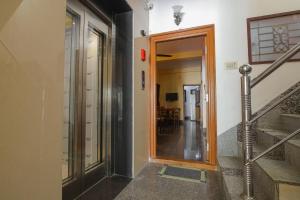 um corredor com uma porta que leva a um quarto com escadas em Manora Residency em Pondicherry