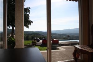 a sliding glass door with a view of a patio at Casa Avó Chiquinha in Montalegre