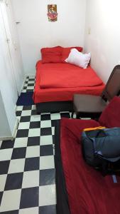 a room with two beds and a checkered floor at Manana House in Tbilisi City