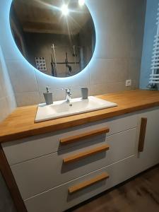 a bathroom with a sink and a mirror at Kaszubski dom pod lasem in Studzienice +32 photos
