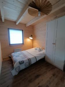 a bedroom with a bed and a ceiling fan at Kaszubski dom pod lasem in Studzienice