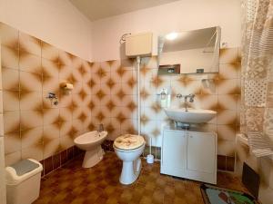 a bathroom with a sink and a toilet and a mirror at Apartmani Ružić in Jadranovo +27 photos