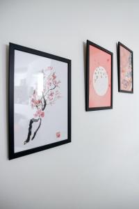 a group of four framed pictures on a wall at Charmant studio, au cœur de la ville de Riom in Riom