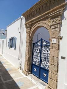 an entrance to a building with a blue door at Jasmine Suites Poolhouse Rhodos in Koskinou