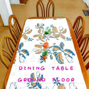 a dining table with a table cloth with plants on it at Budget House Near Penang Airport Bayan Lepas Penang in Bayan Lepas