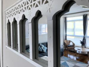 a room with a row of mirrors on the wall at Apartamento El Espigón (Cimadevilla) in Gijón
