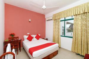 a bedroom with a bed and a window at The Ocean Pearl Resorts in Panadura