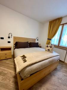 a bedroom with a large bed and a large window at Alpine Escape 2 in Valdisotto