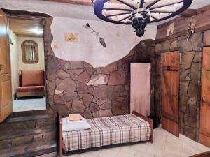 a room with a stone wall with a bed and a ceiling at Inn Khlibodarskiy in Khlibodarske