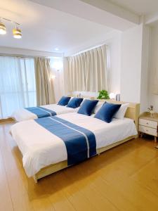 a bedroom with two large beds with blue pillows at サクラシャドウ　スカイツリー in Tokyo