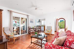 a living room with a couch and a table at Villa Nayade in Cala en Blanes