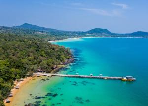 an aerial view of a beach with a pier at Tree House Bungalows in Koh Rong Island