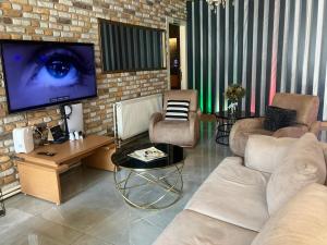 a living room with a couch and a tv at Samsun Osmanlı Otel in Samsun