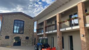 a tractor parked in front of a building at Fuoridicampo rossa in Roncovetro