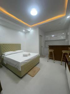 a bedroom with a bed and a table and chairs at JP Suites & Residences in Tayabas