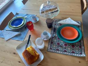 a table with a plate of bread and a bowl of soup at Fuoridicampo rossa in Roncovetro