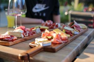 a table with two plates of food and a glass of wine at Lodges & Nature - 47 in Avignon