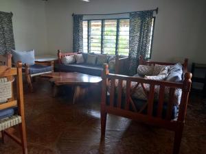 a living room with couches and a coffee table at Malaika Holiday Villas in Diani Beach