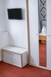 einen Spiegel in einem Zimmer mit einem TV an der Wand in der Unterkunft Hotel Constantin in Trier