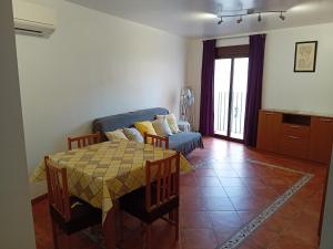 a living room with a table and a couch at Lovely y Cozy Apartments in Chulilla