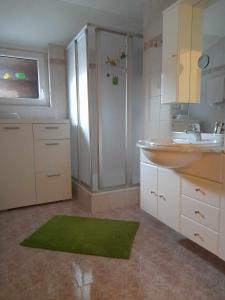 a bathroom with a sink and a sinkessment at Hotel-Pension Wolfgang in Saalbach Hinterglemm