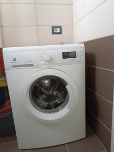 a white washing machine in a small room at Sermi's House in Shkodër