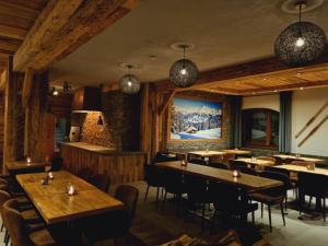 a dining room with wooden tables and chairs at Hotel Pension Annerlhof in Maria Alm am Steinernen Meer