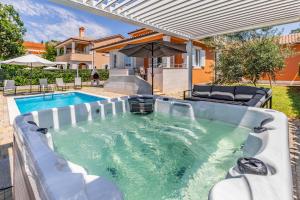 a hot tub in the backyard of a house at Villas Lotus with Pool and Jacuzzi in Pula