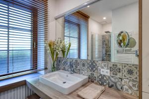 a bathroom with a sink and a mirror at Villa Ganzstein in Mürzzuschlag