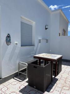 a small table in a room with a wall at Casa Lia and friends in Playa Blanca