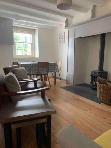 a room with a living room with a fire place at Character Cottage Nr Betws Y Coed. in Betws-y-coed