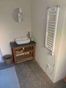a bathroom with a sink and a mirror at Character Cottage Nr Betws Y Coed. in Betws-y-coed