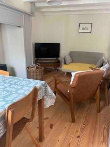 a living room with a couch and a table at Character Cottage Nr Betws Y Coed. in Betws-y-coed