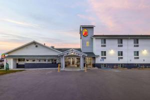 a large white building with a clock tower on it at Super 8 by Wyndham Belgrade/Bozeman Airport in Belgrade