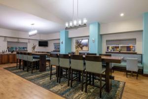 a dining room with a long table and chairs at Super 8 by Wyndham Belgrade/Bozeman Airport in Belgrade