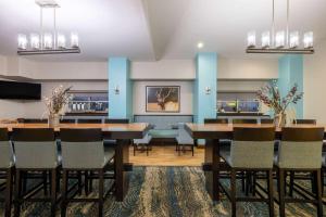 a dining room with blue walls and tables and chairs at Super 8 by Wyndham Belgrade/Bozeman Airport in Belgrade
