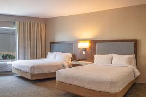 a hotel room with two beds and a window at Hampton Inn & Suites Boerne in Boerne