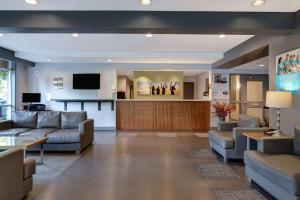 a lobby with couches and a waiting room at Days Inn by Wyndham Victoria Airport Sidney in Sidney