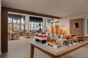 a buffet in a hotel with food on a table at Hilton Garden Inn La Romana in La Romana