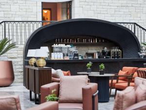 a restaurant with a fireplace with chairs and tables at Swissotel Uludag Bursa in Bursa