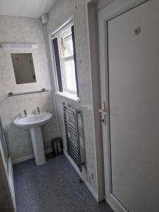 a bathroom with a sink and a window and a mirror at Vance House in Blackpool +4 photos